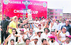 The winning team celebrate with the trophy in Srinagar