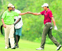 India�s Anirban Lahiri (L) and Gaganjeet Bhullar during the second day of the Omega World Cup Asian Qualifying tournament in Petaling Jaya near Kuala Lumpur on Thursday