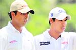 Anirban Lahiri (L) and Gaganjeet Bhullar of India during the third round of the Omega Mission Hills World Cup Asian Qualifying event in Petaling Jaya