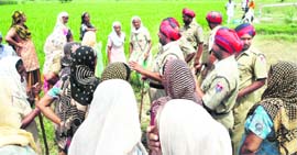 Cops try to calm protesters at Gobindpura village in Mansa on Saturday.