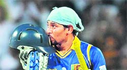 Lankan captain Tillekeratne Dilshan kisses his helmet after scoring a century in the first Twenty20 match against Australia at Pallekele on Saturday.