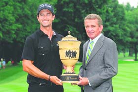 Australia�s Adam Scott poses with the trophy alongside PGA TOUR commissioner Tim Finchem after the final round of the World Golf Championships-Bridgestone Invitational in Akron, Ohio on Sunday