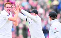 Stuart Broad (L) celebrates after dismissing Sachin Tendulkar.