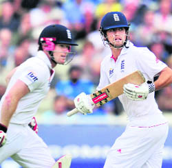 Eoin Morgan (L) and Alastair Cook during the third day of the third Test at Edgbaston 