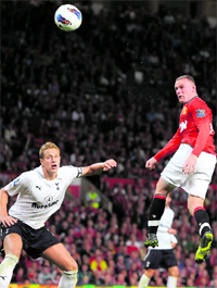 Manchester United's Wayne Rooney (R) scores in Manchester on Monday