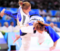 Belgium's Charline Van Snick (R) fights against Romania's Alina Dumitru during their qualifying match in the - 48kg category at the Judo World Championships in Paris on Tuesday