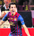 Barcelona's Cesc Fabregas celebrates after scoring against Porto in the UEFA Super Cup in Monaco on Saturday. 