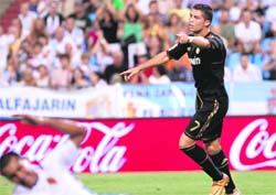 Real Madrid's forward Cristiano Ronaldo celebrates after scoring the second goal against Zaragoza in the Spanish League at La Romareda Stadium in Zaragoza