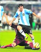 Argentina�s Lionel Messi takes the ball from Venezuela�s Ternando Amorebita during the FIFA Freindly International match in Kolkata on Friday.