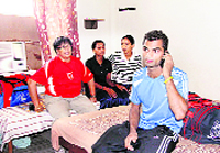Members of the Indian cycling squad sit in their rented room at the Gurdwara Dukhniwaran Sahib in Patiala on Wednesday