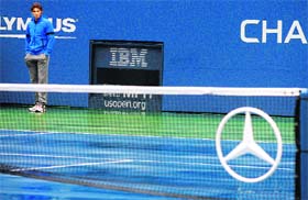 Rafael Nadal looks at the rain-covered court at the US Open