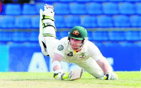 Australia's Phillip Hughes dives during the first day of second Test against Sri Lanka in Kandy on Thursday