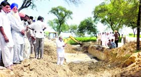 JCB machines being used to dig state highway to divert flood water from fields in Abohar.