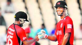T&T�s Adrian Barath (L) celebrates the win with Lendl Simmons in Hyderabad on Tuesday.