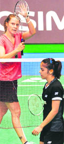 Juliane Schenk of Germany (L) acknowledges the cheers after her victory over Saina Nehwal at the Japan Open in Tokyo on Saturday. 