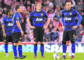 Manchester United�s players react after Stoke City's Peter Crouch (not pictured) scored during their match in Stoke on Saturday.