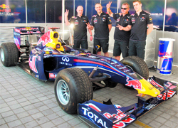 Red Bull Racing team technicians with their Formula One car, which they assembled as part of an event in New Delhi on Friday
