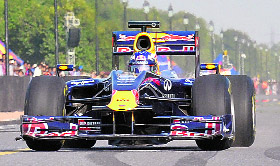 Red Bull support driver Daniel Ricciardo of Australia shows off the paces of their Formula One car at Rajpath in New Delhi on Saturday