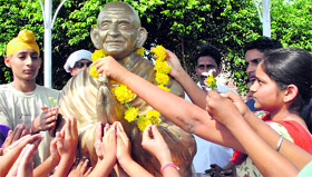 Children pay tributes to Mahatma Gandhi on the occasion of Gandhi Jayanti in Patiala on Sunday.