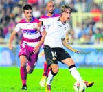Valencia's midfielder Sergio Canales (R) vies for the ball with Granada's midfielder Fran Rico (L) during the Spanish league football match at the Mestalla stadium in Valencia on Saturday. Valencia won 1-0.