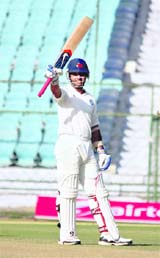 Rest of India�s Ajinkya Rahane raises his bat after completing his century against Rajasthan in Jaipur. 