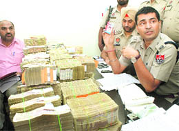 Income Tax and police officials count hawala money seized by Rajpura Police on Monday. 