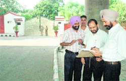 Revenue officials outside the residence of IG (Lokpal) SL Gakhar on Monday. 