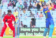 Cape Cobras� Dane Vilas plays a shot as Trinidad & Tobago wicket keeper Sunil Narine looks on during their Champions League T20 match in Chennai on Tuesday. T&T won the match by two wickets. �