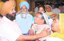 Dubai-based businessman SPS Oberoi with the families of the youths who are languishing in Dubai jails, in Jalandhar