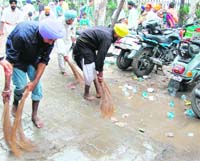 Volunteers clean the route of the nagar kirtan in Amritsar on Saturday.