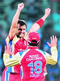 RCB�s Dirk Nannes (L) and Virat Kholi celebrate the dismissal of Mumbai Indians� Aiden Blizzard during the Champions League Twenty20 final at the M.A Chidambaram Stadium in Chennai on Sunday
