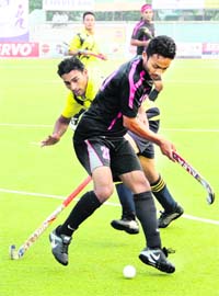 A match in progress between Indian Oil Mumbai and EME Jalandhar in the Surjit Hockey tournament on Monday
