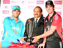 Indian captain MS Dhoni (L) and England captain Alastair Cook (R) alongwith CEO Bharati Airtel Limited Sharlin Thayali unveil the trophy for the India vs England ODI series during a press conference in Hyderabad on Wednesday