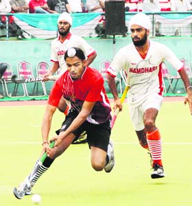 Teams ONGC and Namdhari XI in action during the 28th Indian Oil Servo Surjit Hockey Tournament in Jalandhar on Thursday