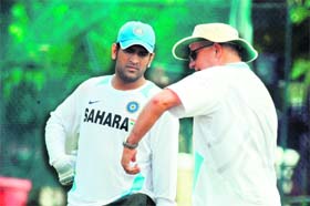 MS Dhoni (L) and coach Duncan Fletcher talk during a practice session at Rajiv Gandhi International Stadium in Hyderabad on Thursday