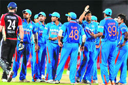 Indian players look on as Kevin Pietersen walks off after being dismissed during the first ODI in Hyderabad