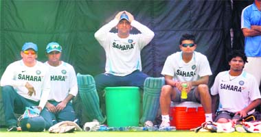 MS Dhoni (C) adjusts his cap as he sits with Ravindra Jadeja (R) Suresh Raina (2nd R) and Parthiv Patel (L) during a practice session in New Delhi on Sunday