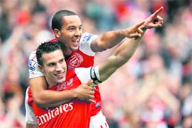 Arsenal�s Robin Van Persie (bottom) celebrates his goal against Sunderland with Theo Walcott in London on Sunday