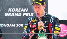 Red Bull-Renault driver Sebastian Vettel celebrates his victory with champagne on the podium after the Formula One Korean Grand Prix in Yeongam on Sunday
