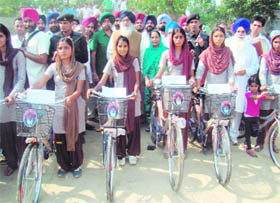 Chief Minister Parkash Singh Badal gives away bicycles to girl students in Gidderbaha assembly constituency of Muktsar on Monday. Meanwhile, Umeed Foundation, run by PCC general secretary and former Sangrur MLA Arvind Khanna, also distributed bicycles among 233 meritorious students of Class VIII and Class X, in Sangrur