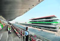 A security guard walks in the main grandstand at the newly-inaugurated Buddh International Circuit in Greater Noida on Tuesday