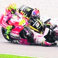 Ducati rider Valentino Rossi (L), Yamaha rider Colin Edwards (top) and Honda rider Marco Simoncelli (C) collide during the Malaysian MotoGP on Sunday