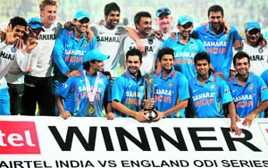 Indian players celebrate with their trophy after winning the fifth and final one-day international between India and England at the Eden Gardens in Kolkata on Tuesday. India brushed aside England by 95 runs to sweep the series 5-0. India have beaten England in 16 of their last 18 one-day encounters at home