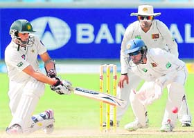 Pakistan's Azhar Ali (L) plays a shot on the second day of the second Test against Sri Lanka at Dubai's international stadium on Thursday