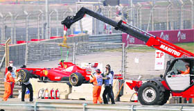 The car of Ferrari driver Felipe Massa is removed from the track after he crashed during the qualifying session on Saturday.