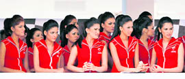 Formula One grid girls watch the qualifying session for the Indian F1 Grand Prix at the Buddh International Circuit in Greater Noida on Saturday.