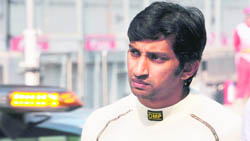 Hispania-Cosworth driver Narain Karthikekyan walks in the pit lane on Saturday.