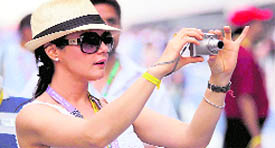 Actress Priety Zinta busy clicking pictures during the drivers� parade for the Indian Formula One Grand Prix at the Buddh International Circuit in Greater Noida on Sunday.
