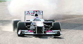 Sauber-Ferrari driver Kamui Kobayashi runs with smoke at the second turn right after the start of Formula One's Indian Grand Prix at the Buddh International circuit in Greater Noida on Sunday.