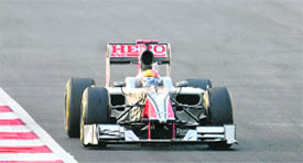 Hispania-Cosworth driver Narain Karthikekyan leads the pack during the Indian Grand Prix on Sunday.